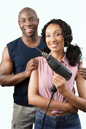 drilling african american - Couple with power drill, portrait Stock Photo - Premium Royalty-Free, Code: 693-06016126