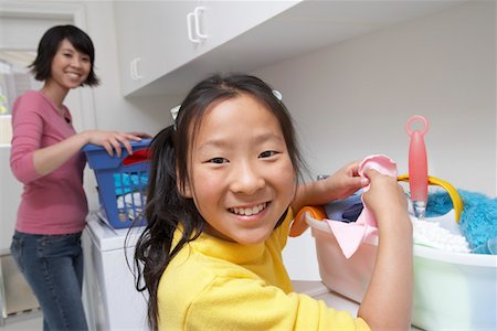 simsearch:693-06021547,k - Mother and daughter (7-9) doing laundry Foto de stock - Royalty Free Premium, Número: 693-06016157