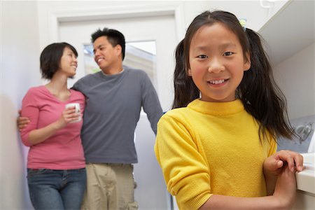 Family with daughter (7-9) in laundry room Stock Photo - Premium Royalty-Free, Code: 693-06016153