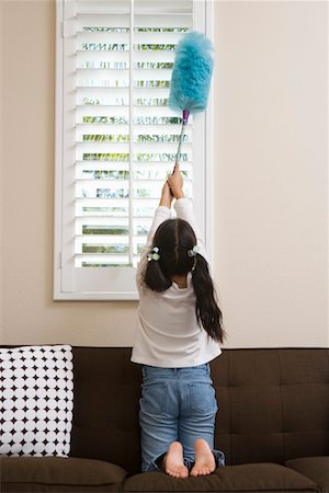 Girl (10-12) dusting window Stock Photo - Premium Royalty-Free, Code: 693-06016235