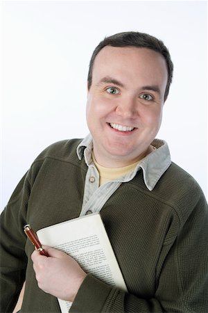 fat man facial expression - Portrait of mid-adult man holding pen and book Stock Photo - Premium Royalty-Free, Code: 693-06016293