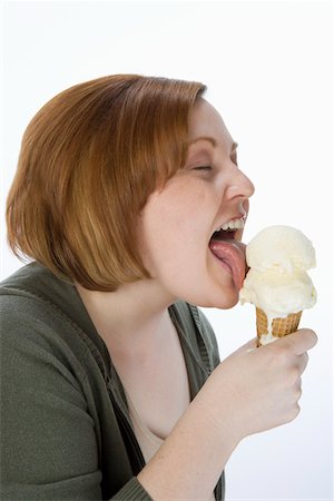 Mid-adult woman eating ice cream, portrait Stock Photo - Premium Royalty-Free, Code: 693-06016335