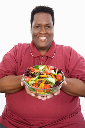 fat man facial expression - Man Holding Salad Stock Photo - Premium Royalty-Free, Code: 693-06016393