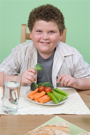 Overweight boy having healthy meal. Stock Photo - Premium Royalty-Free, Code: 693-06016429