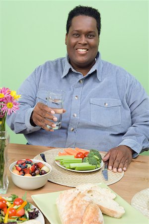 fat people eating healthy food - Man Eating Fruits and Vegetables Stock Photo - Premium Royalty-Free, Code: 693-06016434