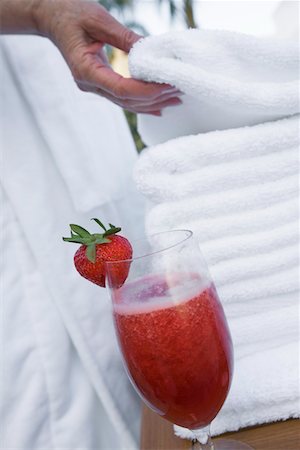 senior and spa - Senior woman holding towel near strawberry cocktail, close-up Stock Photo - Premium Royalty-Free, Code: 693-06016577
