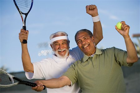 Two male tennis players cheering on court Stock Photo - Premium Royalty-Free, Code: 693-06016665