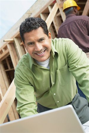 simsearch:693-06016692,k - Smiling Construction Worker Using Laptop on construction Site Stock Photo - Premium Royalty-Free, Code: 693-06016696