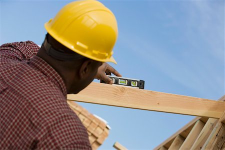 Construction worker using spirit level on building Stock Photo - Premium Royalty-Free, Code: 693-06016718