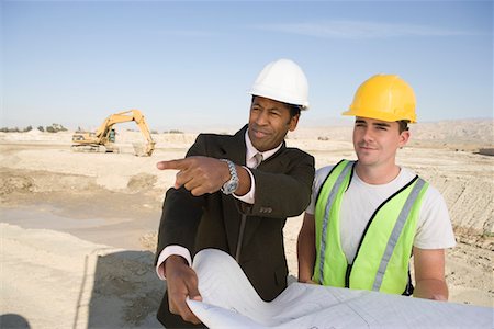 Surveyor and construction worker holding blueprint Stock Photo - Premium Royalty-Free, Code: 693-06016793