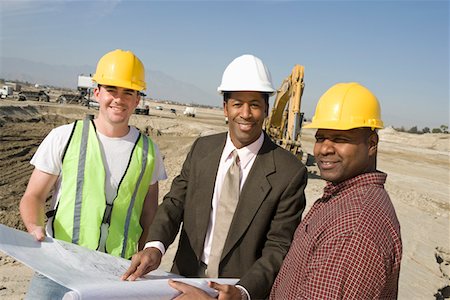 Surveyor and construction workers on site, portrait Stock Photo - Premium Royalty-Free, Code: 693-06016800