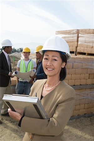 simsearch:632-03652237,k - Two architects standing on construction site holding blueprints Stock Photo - Premium Royalty-Free, Code: 693-06016825
