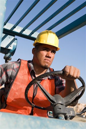 Construction worker driving vehicle Stock Photo - Premium Royalty-Free, Code: 693-06016867