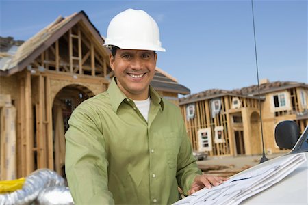 Architect holding blueprints on construction site Stock Photo - Premium Royalty-Free, Code: 693-06016911