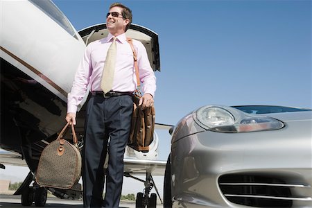 Homme d'affaires Mid devant la voiture et avion. Photographie de stock - Premium Libres de Droits, Code: 693-06016990