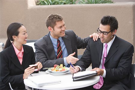 Three business people having meeting at lunch Stock Photo - Premium Royalty-Free, Code: 693-06017348