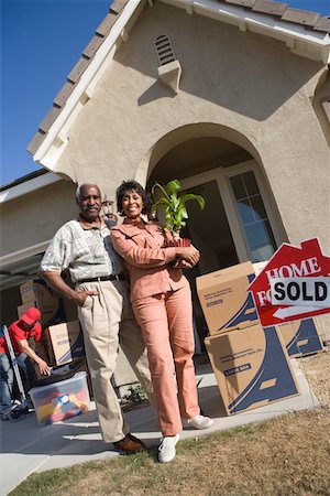 Middle-aged couple in front of their new house Stock Photo - Premium Royalty-Free, Code: 693-06017399