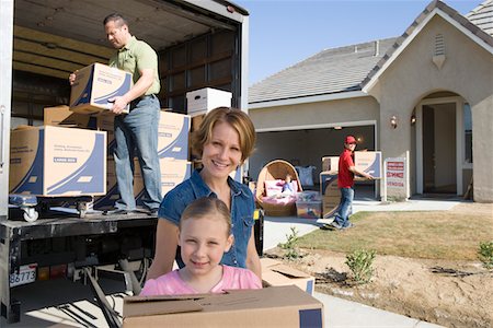 family outside new home - Portrait of family with daughter (7-9) unloading truck Stock Photo - Premium Royalty-Free, Code: 693-06017441