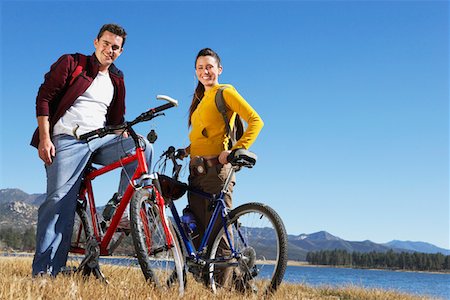 Young Couple on Mountain Bikes by lake Stock Photo - Premium Royalty-Free, Code: 693-06017510