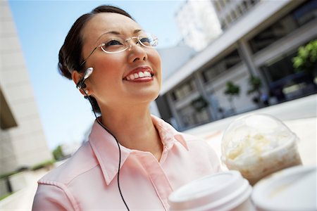 errand - Businesswoman Using Cell Phone with hands free, outdoors Stock Photo - Premium Royalty-Free, Code: 693-06017525
