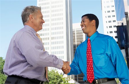 Businessmen shaking hands, outdoors Stock Photo - Premium Royalty-Free, Code: 693-06017523