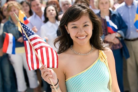 Young woman holding American flag, portrait Stock Photo - Premium Royalty-Free, Code: 693-06017586