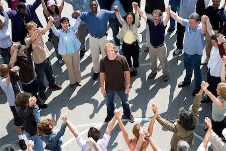 rally not car - Crowd with arms raised surrounding young man Stock Photo - Premium Royalty-Free, Code: 693-06017622