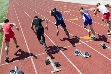 Male sprinters leaving starting blocks Stock Photo - Premium Royalty-Free, Code: 693-06017676