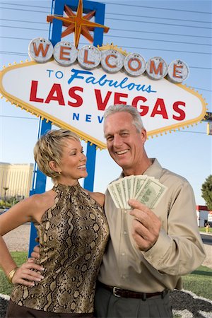 Middle-aged couple in front of Welcome to Las Vegas sign, portrait Stock Photo - Premium Royalty-Free, Code: 693-06018071