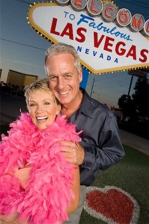Middle-aged couple in front of Welcome to Las Vegas sign, portrait Stock Photo - Premium Royalty-Free, Code: 693-06018082