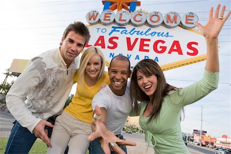 simsearch:693-06018149,k - Two women and two men in front of Welcome to Las Vegas sign, group portrait Stock Photo - Premium Royalty-Free, Code: 693-06018102