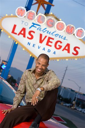 simsearch:693-06018149,k - Man sitting on bonnet of car in Las Vegas Stock Photo - Premium Royalty-Free, Code: 693-06018126