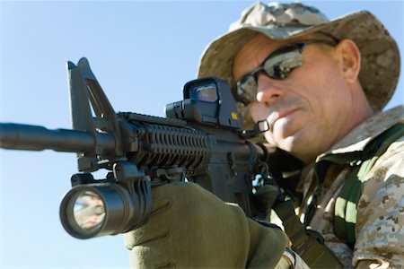 simsearch:841-07202088,k - Soldier aiming rifle, outdoors, (close-up) Stock Photo - Premium Royalty-Free, Code: 693-06018184