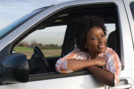 Portrait of mid-adult woman in car window Stock Photo - Premium Royalty-Free, Code: 693-06018219