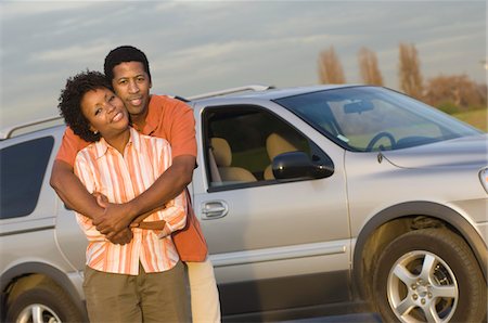 Portrait of mid-adult couplein front of car Stock Photo - Premium Royalty-Free, Code: 693-06018222