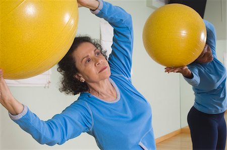 pilates african american - Senior Woman Using Exercise Ball in Fitness Class Stock Photo - Premium Royalty-Free, Code: 693-06018290