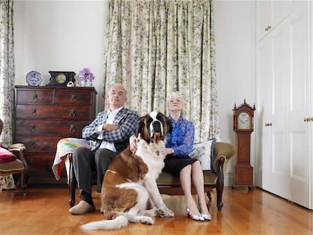 Senior couple posing in living room with dog Stock Photo - Premium Royalty-Free, Code: 693-06018491