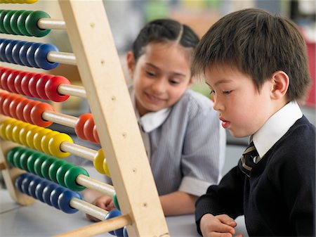 Elementary students using abacus in classroom Stock Photo - Premium Royalty-Free, Code: 693-06018552