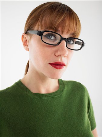 Woman in studio wearing glasses, head and shoulders Stock Photo - Premium Royalty-Free, Code: 693-06018615