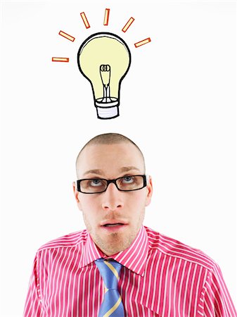 Man in glasses looking up, head and shoulders, below illustrated light bulb Stock Photo - Premium Royalty-Free, Code: 693-06018646