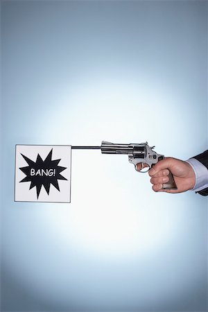 person hand on gun - Man firing pistol with bang flag, close-up of hand Stock Photo - Premium Royalty-Free, Code: 693-06018684