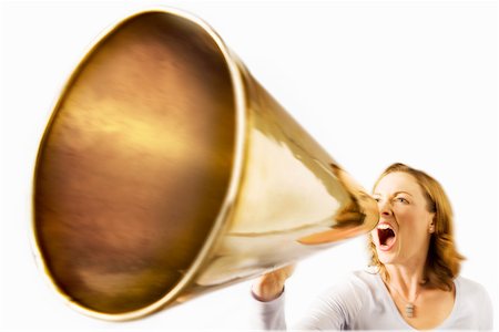 Woman shouting through megaphone, studio shot Stock Photo - Premium Royalty-Free, Code: 693-06018739