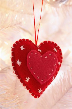 Heart shaped decoration hanging on Christmas tree, close-up Stock Photo - Premium Royalty-Free, Code: 693-06018765