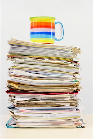 Coffee Mug on Stack of Files Stock Photo - Premium Royalty-Free, Code: 693-06018795