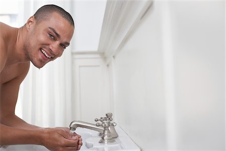 Young Man Washing in Basin Stock Photo - Premium Royalty-Free, Code: 693-06018841