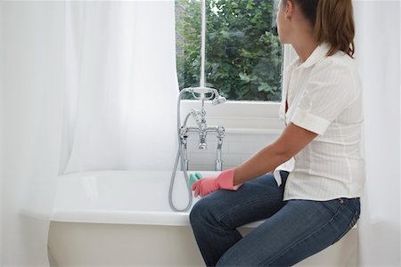 sponge bath woman - Young woman cleaning bathroom Stock Photo - Premium Royalty-Free, Code: 693-06018858