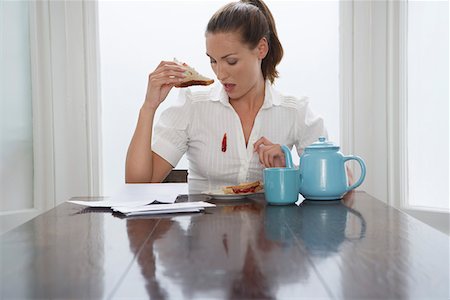 spill accident - Woman with stain on blouse at dining room table Stock Photo - Premium Royalty-Free, Code: 693-06018867