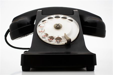 Old fashioned black telephone in studio Stock Photo - Premium Royalty-Free, Code: 693-06018926