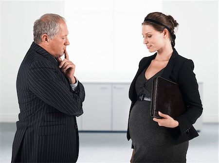 pregnant surprise - Boss talking to pregnant businesswoman, half length Stock Photo - Premium Royalty-Free, Code: 693-06018996