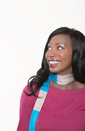 Young, smiling Woman wearing scarf, looking away Stock Photo - Premium Royalty-Free, Code: 693-06019063